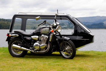 Black Motorbike Bike with side hearse in front of a large lake