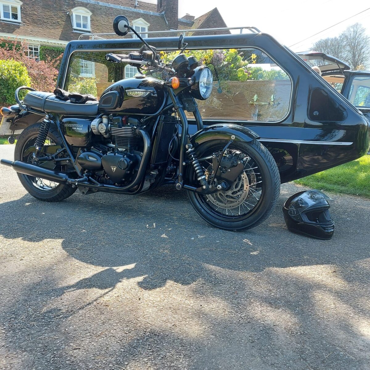 Black Triumph Bonneville Bike with side hearse & coffin side hearse